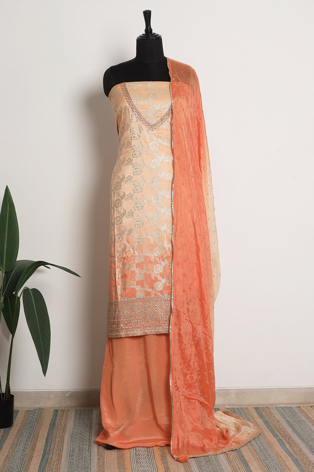PEACH OMBR BANARASI UNSTITCHED SUIT SET AND A CREPE SILK PANT PIECE PAIRED WITH A MATCHING BUTI WORK CHIFFON DUPATTA AND GOLD DETAILS. - Seasons India PEACH OMBR BANARASI UNSTITCHED SUIT SET AND A CREPE SILK PANT PIECE PAIRED WITH A MATCHING BUTI WORK CHIFFON DUPATTA AND GOLD DETAILS. - Seasons India