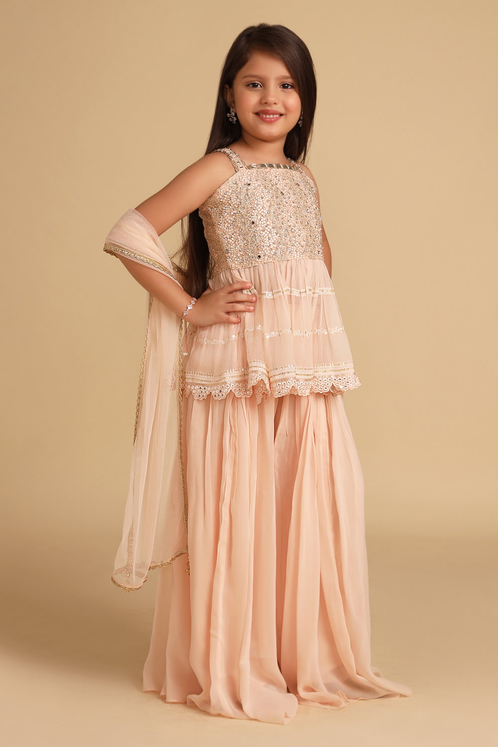 KIDS PASTEL PEACH PALAZZO PANT SET AND A SOFT PEPLUM STYLE EMBROIDERED  KURTA TOP PAIRED WITH A MATCHING DUPATTA AND SILVER DETAILS. - Seasons India