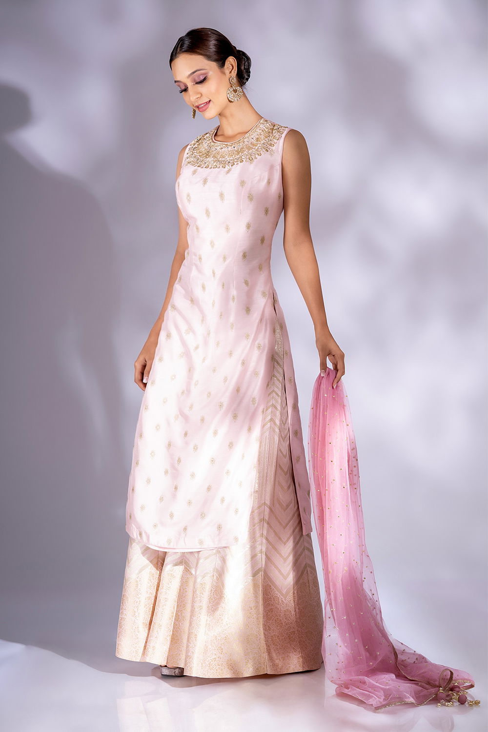 BLUSH PINK BANARASI PALAZZO PANT SET WITH A LONG KURTA TOP WITH GOLD BUTIS AND NECKLINE EMBROIDERY PAIRED WITH A ROUGE PINK DUPATTA. Seasons India